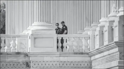  ?? The Associated Press ?? STANDING WATCH: Capitol Hill Police officers stand watch outside the House of Representa­tives Thursday on Capitol Hill in Washington, a day after a gunman opened fire on a lawmakers playing baseball and wounded House Majority Whip Steve Scalise at a...