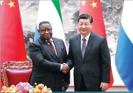  ?? FENG YONGBIN / CHINA DAILY ?? President Xi Jinping shakes hands with visiting Sierra Leonean President Julius Maada Bio during their meeting at the Great Hall of the People in Beijing on Wednesday.