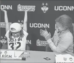  ?? MICHAEL MCANDREWS/HARTFORD COURANT ?? UConn women’s lacrosse coach Katie Woods applauds and Kaleigh Thereault celebrates after she signs her letter of intent and dons an official UConn women’s lacrosse jersey.