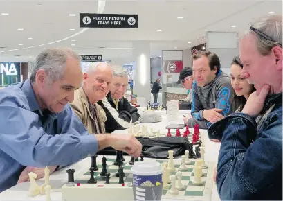  ??  ?? Some of the regulars gather for a game of chess at the Park Royal food court in West Vancouver. While some members of the loose group have played in the mall for decades, they have been told to leave or face being hauled out by police.