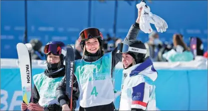  ?? FENG YONGBIN / CHINA DAILY ?? Gu Ailing (center) celebrates on Feb 8 with silver medalist Tess Ledeux (right) of France and bronze medalist Mathilde Gremaud of Switzerlan­d after winning the women’s freeski big air final at the Beijing Winter Olympics.