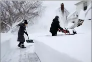  ?? CRAIG RUTTLE — THE ASSOCIATED PRESS ?? Susan Iannuzzi, left and Linda Marzell of Binghamton,
N.Y., clear a sidewalk after a heavy snowfall on street in Binghamton, N.Y., Thursday, Dec. 17. Binghamton
Airport reported 39.1 inches of snow and another spot in Binghamton reported 41.0 inches, according to the National Weather Service.