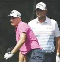  ?? The Associated Press ?? LEADERS: Aaron Wise, left, and Marc Leishman, right, watch Wise’s shot off the 18th tee during the third round of the AT&T Byron Nelson golf tournament Saturday in Dallas, Texas.