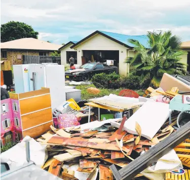  ?? Picture: ALIX SWEENEY ?? CRISIS NOT OVER: Kokoda St, Idalia with clean ups after the Townsville flood.