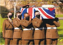  ?? JOE GIDDENS AP ?? The coffin of “Captain Tom” Moore is carried by members of the Armed Forces during his funeral Saturday in Bedford, England.