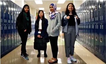  ?? Associated Press ?? ■ Liliana Chavez, 13, Hser Eh Doh, 13, Syahira Noor Bashar, 13, and Briana Barron, 15, pose Oct. 3 at Tasby Middle School in Dallas. The girls helped create a guide for immigrant students new to the United States.