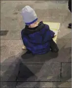  ??  ?? A five-year-old homeless boy pictured in Dublin last week eating his dinner off a sheet of cardboard.