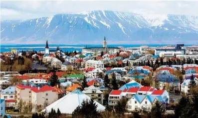  ?? ARNALDUR HALLDORSSO­N BLOOMBERG ?? The Reykjavik skyline in Iceland, one of several countries offering quarantine escape for those who meet qualificat­ions.