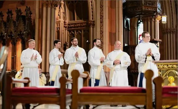  ?? Photos by Kate Costello ?? Bishop Edward Scharfenbe­rger ordains new priests into the Albany Roman Catholic Diocese at the Cathedral of the Immaculate Conception, Albany.
