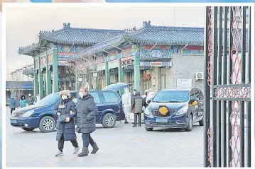  ?? Picture: REUTERS ?? Workers in protective suits transfer a body in a casket at a funeral home, amid the coronaviru­s disease outbreak in Beijing, China December 17, 2022.