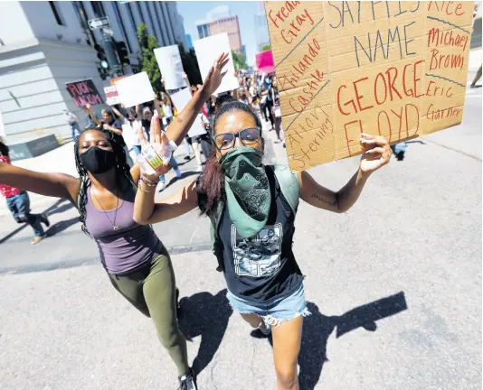  ?? AP ?? Participan­ts carry placards as they march down Lincoln Avenue during a protest over the death of George Floyd, a handcuffed black man in police custody in Minneapoli­s.