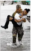  ?? DAVID J. PHILLIP / AP ?? Houston Police SWAT officer Daryl Hudeck carries Connie Pham and her 13-month-old son Aiden after rescuing them from their home.