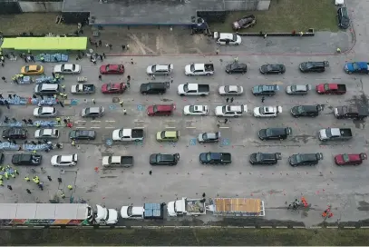  ?? Picture: Reuters ?? DRINKING HOLE. People queue for water at Butler Stadium after the Texan city of Houston implemente­d a boil water advisory following an unpreceden­ted winter storm at the weekend.