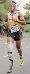  ?? ?? MHLENGI Gwala, a member of the Murray & Roberts Running Club and wearing his expensive running blade, puts in the hard yards in a road race through the streets of Durban.