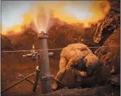  ?? EFREM LUKATSKY — THE ASSOCIATED PRESS ?? Ukrainian servicemen of the 28th Separate Mechanised Brigade fires a 122mm mortar toward Russian positions at the front line near Bakhmut, Donetsk region, Ukraine, earlier this month.