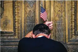  ?? Erin Schaff / New York Times ?? A man prays outside of the Supreme Court on Saturday after Judge Amy Coney Barrett’s nomination was announced.