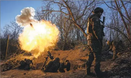  ?? UKRAINIAN FORCES Photograph­s by Evgeniy Maloletka Associated Press ?? target Russian positions with mortar fire near Bakhmut, a strategic city in the Donetsk region, on Wednesday.