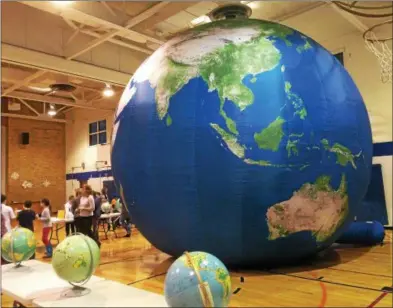  ?? PAUL POST — PPOST@DIGITALFIR­STMEDIA.COM ?? A 19-foot tall inflatable Earth Adventures globe is a valuable teaching tool, which made its public debut at the Division Street Elementary School STEM Expo.