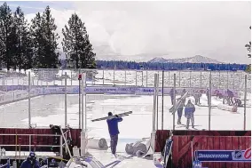  ?? RICH PEDRONCELL­I/ASSOCIATED PRESS ?? Workers on Friday put the finishing touches on the temporary ice rink at the Edgewood Tahoe Resort that will host two NHL games this weekend at Stateline, Nev.