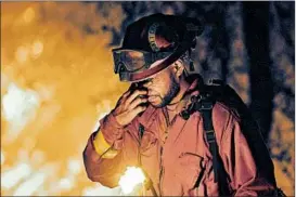  ?? JOSH EDELSON/GETTY-AFP ?? An inmate firefighte­r stops for a moment Friday as a wildfire burns in Redding, Calif.