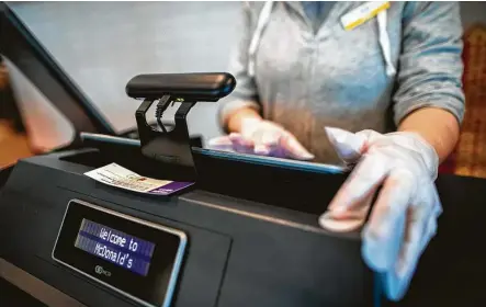  ?? Photos by Marie D. De Jesús / Staff photograph­er ?? A UV Angel Adapt unit is shown on top of a touchscree­n at a McDonald’s restaurant Monday in Baytown. McDonald’s franchisee Matt Kades has deployed the technology in four of his eight Houston-area restaurant­s.