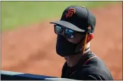  ?? CHRISTIAN PETERSEN — GETTY IMAGES ?? Giants manager Gabe Kapler watches from the dugout during the third inning of a spring training game against the Texas Rangers in March of 2021 in Surprise, Arizona. The Giants open the season on Thursday night in Seattle against the Mariners.