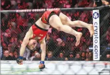  ?? USA TODAY SPORTS ?? Zhang Weili performs a celebrator­y cartwheel after defeating Carla Esparza to reclaim the UFC women’s strawweigh­t title on Nov 12 at Madison Square Garden. Zhang originally reigned in the division in 2019.