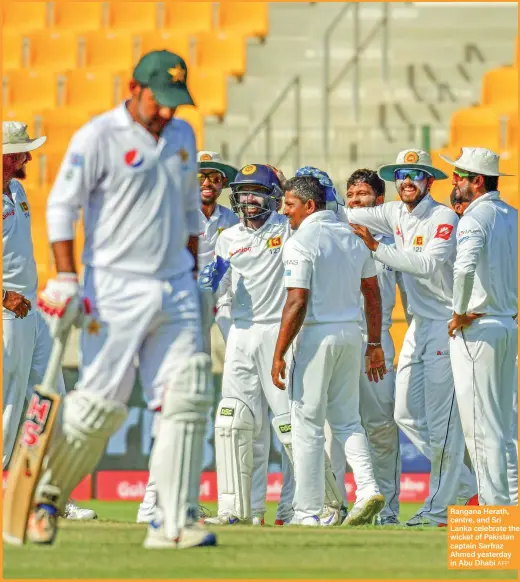  ?? AFP ?? Rangana Herath, centre, and Sri Lanka celebrate the wicket of Pakistan captain Sarfraz Ahmed yesterday in Abu Dhabi