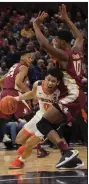  ?? (AP/Lee Luther Jr.) ?? Virginia guard Kihei Clark (0) drives against Florida State defender Malik Osborne (10) during the second half of the Cavaliers’ 61-56 victory over No. 5 Florida State.