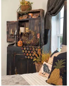  ??  ?? Left: A tall, rustic cabinet in the corner warms the guest bedroom and shows off the simple swags and view out the window while adding both style and storage.