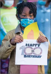  ?? For Faucette. ?? A student holds a sign