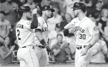  ?? Karen Warren/Staff photograph­er ?? The Astros’ Kyle Tucker (30) celebrates his two-run homer with Alex Bregman and Yuli Gurriel in the sixth inning of Wednesday’s win.