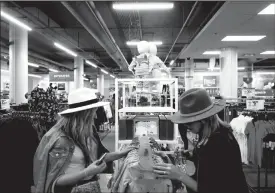  ?? TRIBUNE NEWS SERVICE ?? Customers browse apparel at a renovated Sears store Oct. 4 at Oakbrook Center in Chicago.