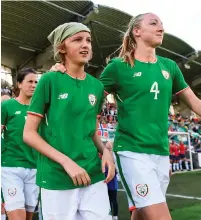  ?? STEPHEN McCARTHY/SPORTSFILE ?? Ireland captain Louise Quinn leads out her team alongside matchday mascot Freya Fitzpatric­k O’Doherty prior to the World Cup qualifier against Norway