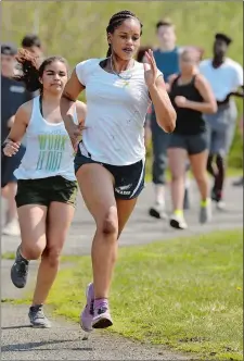  ?? DANA JENSEN/THE DAY ?? Grasso Tech track standout Rhema Phillips, right, and her teammates practice on the track in Groton on May 3.