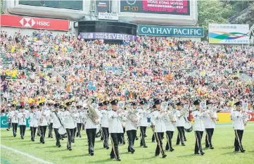  ?? — AFP photo ?? A marching band (bottom) passing the south stand of the Hong Kong Sevens rugby tournament.