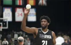  ?? THEMBA HADEBE — THE AP FILE ?? Team Africa’s Joel Embiid, of the 76ers, throws balls to fans during the NBA Africa Game over the summer in Pretoria, South Africa. The NBA has big plans to make a ‘longterm play’ in Africa.