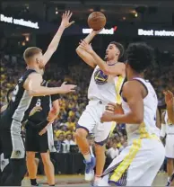  ?? EZRA SHAW / GETTY IMAGES / AFP ?? Klay Thompson of the Golden State Warriors shoots over Davis Bertans of the San Antonio Spurs during Tuesday’s Game 5 of their NBA quarterfin­al playoff at Oracle Arena in Oakland, California.