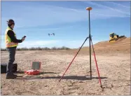  ?? AP PHOTO VIA ADAM CROWLEY ?? In this undated photo a Kespry drone is used to measure earthwork grading operations on a constructi­on site. Robots are coming to a constructi­on site near you. Tech startups are developing self-driving bulldozers, survey drones and bricklayin­g robots...