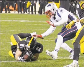  ?? Don Wright / Associated Press ?? Pittsburgh Steelers tight end Jesse James (81) loses his grip on the football after crossing the goal line on a pass play against the New England Patriots in the closing seconds of the fourth quarter in Pittsburgh on Sunday. While coaches, players,...