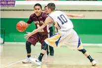  ?? GABRIELA CAMPOS/THE NEW MEXICAN ?? Santa Fe Indian School’s Anders Pecos, left, dribbles past Peñasco’s Dominic Lopez on Thursday during a first round game in the Ben Luján Tournamnet in Pojoaque.