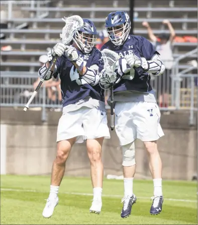  ?? Steve Musco / Yale University Athletics ?? Yale’s Jackson Morrill and teammate Matt Brandau celebrate Morrill’s first-period goal against Penn on Sunday in East Hartford.