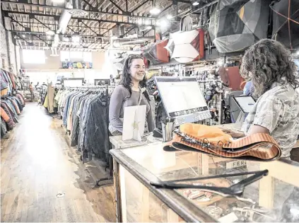  ?? AARON ONTIVEROZ The Denver Post/TNS ?? Louisa Kelly purchases used ski touring gear as Isabel Gourley rings her up at Feral mountain gear. Many independen­t outdoor retailers saw sales declines in 2023, but Feral is thriving thanks to its focus on buying and selling used gear.