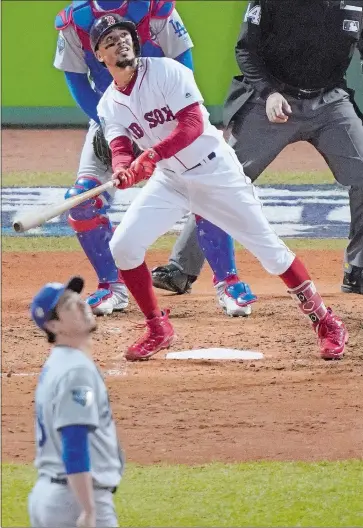  ?? ELISE AMENDOLA/AP PHOTO ?? Mookie Betts of the Boston Red Sox watches his double to the left field wall off Los Angeles Dodgers relief pitcher Kenta Maeda, front, during the seventh inning in Game 2 of the World Series on Wednesday in Boston. The game ended too late for this edition. Visit www.theday.com for complete World Series coverage.