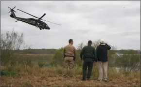  ?? JIM WATSON/AFP ?? U.S. President Donald Trump salutes with Border Patrol agents at the Rio Grande as a U.S. Customs and Border Protection helicopter flies over after his visit to US Border Patrol McAllen Station in McAllen, Texas, on Thursday.