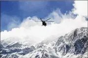  ?? ALI KHODAEI / TASNIM NEWS AGENCY VIA AP ?? A helicopter flies over Mount Dena in a remote part of southern Iran on Monday in search of wreckage from a plane that crashed a day earlier. All 65 people on board were killed, officials said.