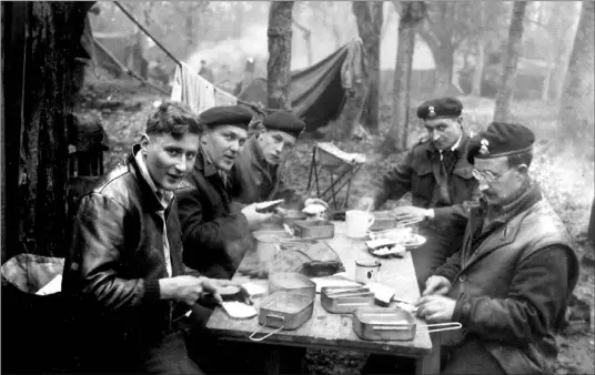  ?? JIM JONES PHOTO ?? The five officers photograph­ed eating lunch in England in the spring of 1944 were, from left, S. V. “Rad” Radley- Walters, Clare Thompson, Doug Bradley, Nairn Boyd and a Capt. Humphries. Thompson was killed three days after D-Day. Boyd also died in...