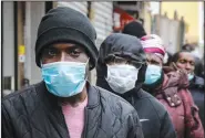  ?? (AP/Bebeto Matthews) ?? People wait Saturday for a distributi­on of masks and food from the Rev. Al Sharpton in the Harlem neighborho­od of New York, after a new state mandate was issued requiring residents to wear face coverings in public because of the coronaviru­s.