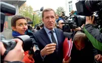  ?? — AFP ?? Paul Magnette is surrounded by journalist­s as he arrives to attend an emergency meeting of all Belgium federal entities on the EUCanada Trade Agreement in Brussels on Monday.