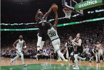  ?? CHARLES KRUPA — THE ASSOCIATED PRESS ?? Milwaukee Bucks guard Jrue Holiday (21) blocks a shot by Boston Celtics guard Marcus Smart (36) in the final seconds of play during the second half of Game 5of an Eastern Conference semifinal Wednesday in Boston. The Bucks